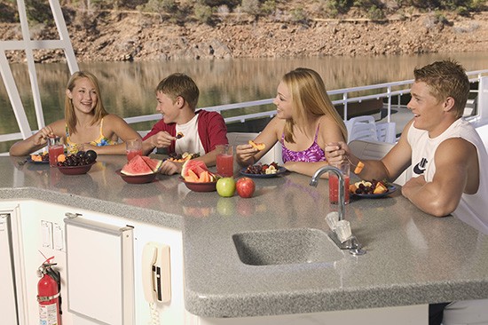 Group of people sitting at a counter on a houseboat