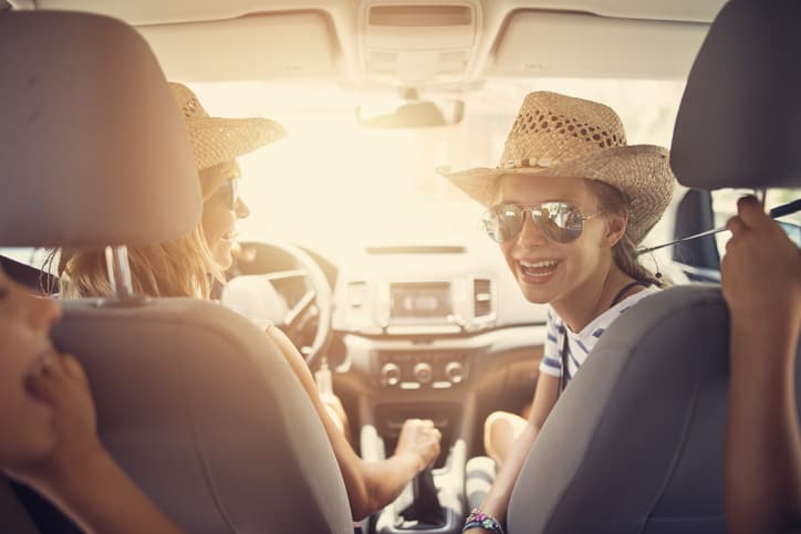 Women in a car smiling