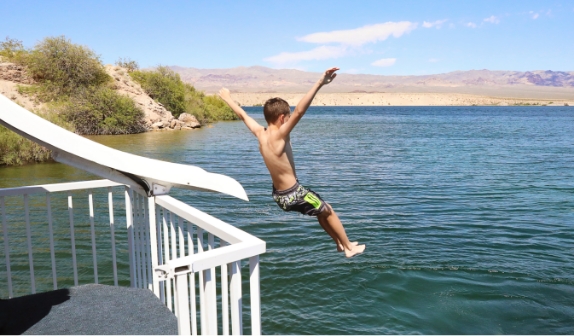 Kid sliding down houseboat water slide